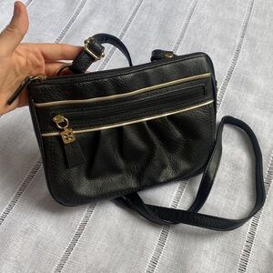 Relic small black crossbody bag with multiple pockets.